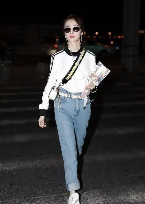 胡冰卿戴墨镜穿白卫衣搭配蓝色牛仔裤现身机场皮肤白皙面带微笑