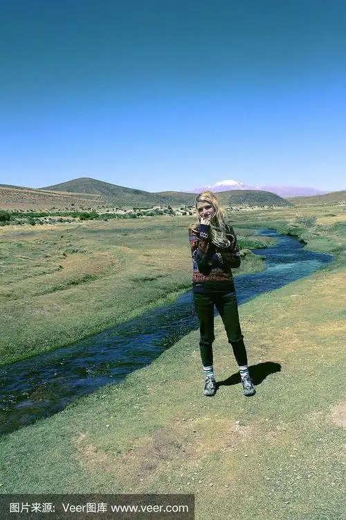 在玻利维亚安第斯高地上的微笑白种人金发女孩河