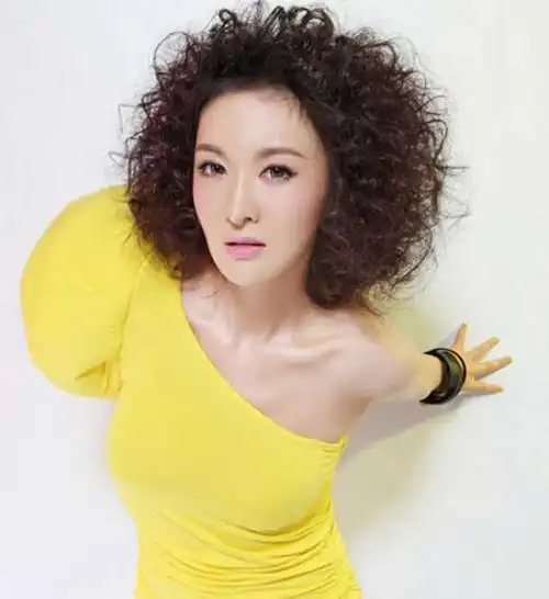 发型点评:这款蓬松凌乱的锡纸烫爆炸头发型,偏分的露额头效果,把小