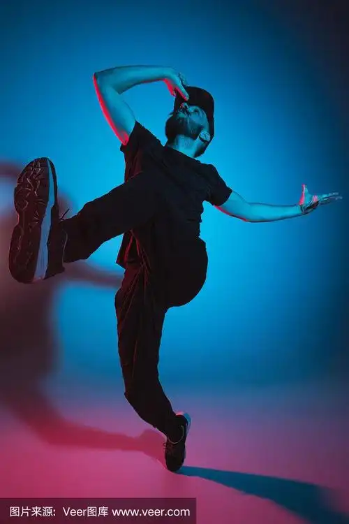 一个街舞男霹雳舞的剪影在多彩的背景上跳舞