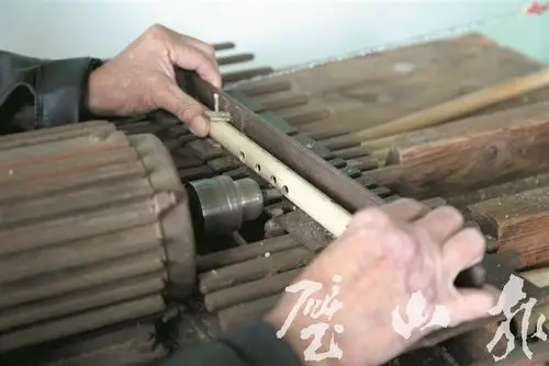 彭开域正在制作竹笛