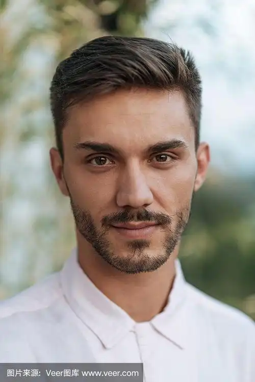 英俊的年轻人的大头照,穿着衬衫,深色头发和胡子