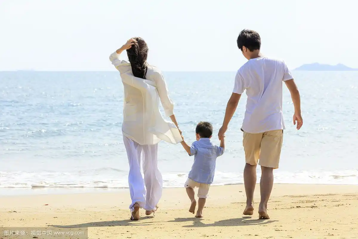 一家三口在海滩散步