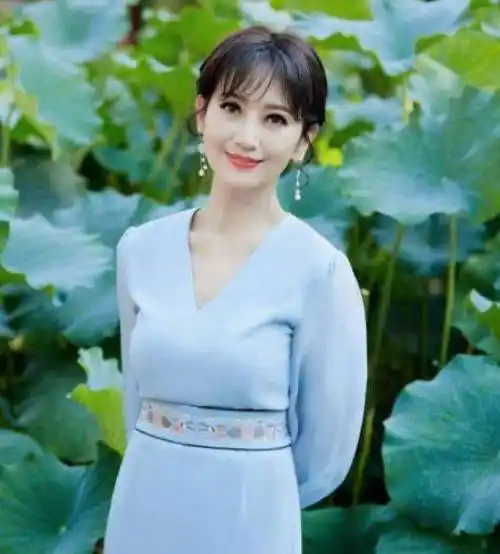 赵雅芝爆出荷塘照!穿裙子撑伞坐在石头上,66岁皮肤白皙五官精致