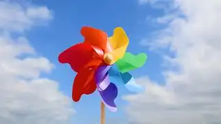 4k蓝天白云下转动的彩色风车意境空镜