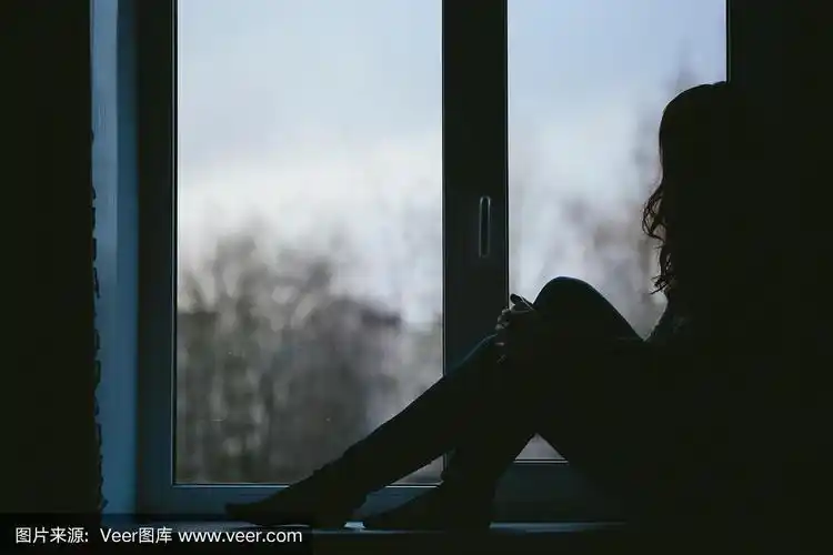 年轻女子性感地坐在窗台上的特写照片