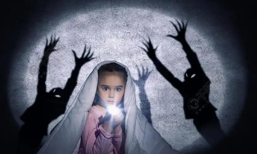 儿童的噩梦可爱的小女孩躺在床上用闪光灯的毯子下