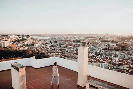 独自站在高楼屋顶上的梦想家,望着葡萄牙里斯本的城市风光照片