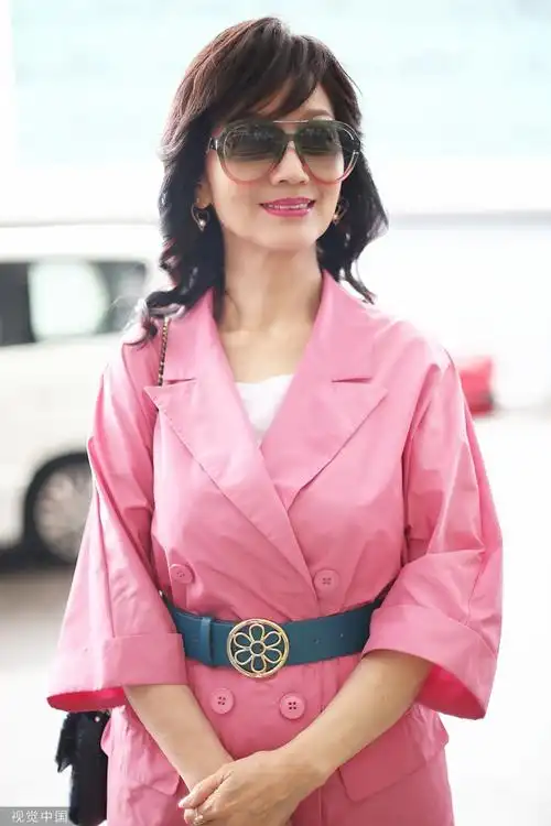 65岁赵雅芝粉色风衣现身机场露甜美微笑气场优雅