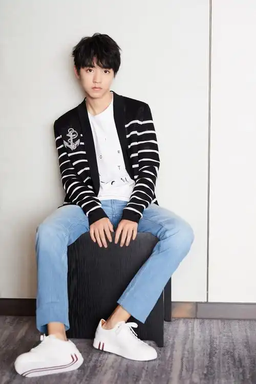 王俊凯身着字母t恤衫配上浅色牛仔裤现身某品牌发布会徽章装饰的衬衫