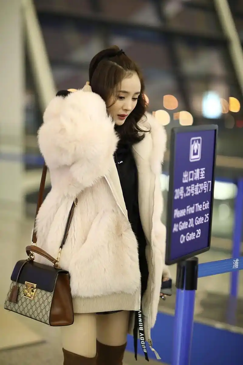 在冬日的阳光下,杨幂身着一件皮草大衣出现在机场,瞬间吸引了众人的