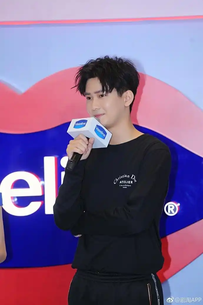 熊梓淇穿黑色卫衣搭配黑色运动裤亮相活动,面带微笑,帅气十足.