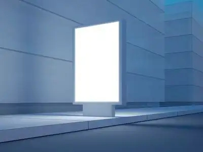 在空荡荡的街道上的白色灯箱.在背景中的现代建筑.3d 渲染照片