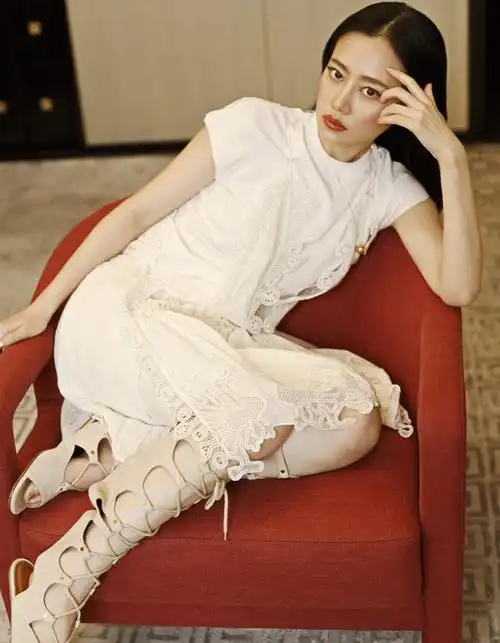 设计无形之中拉长了腿部线条,脚上穿的一双黑色的细高跟鞋站在楼梯上