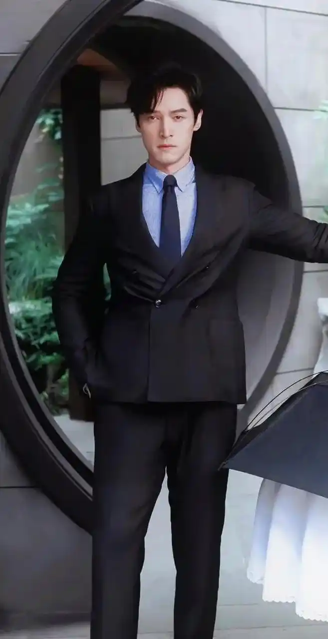 一身黑色西装内搭蓝色衬衫,显得胡歌帅气又干练.