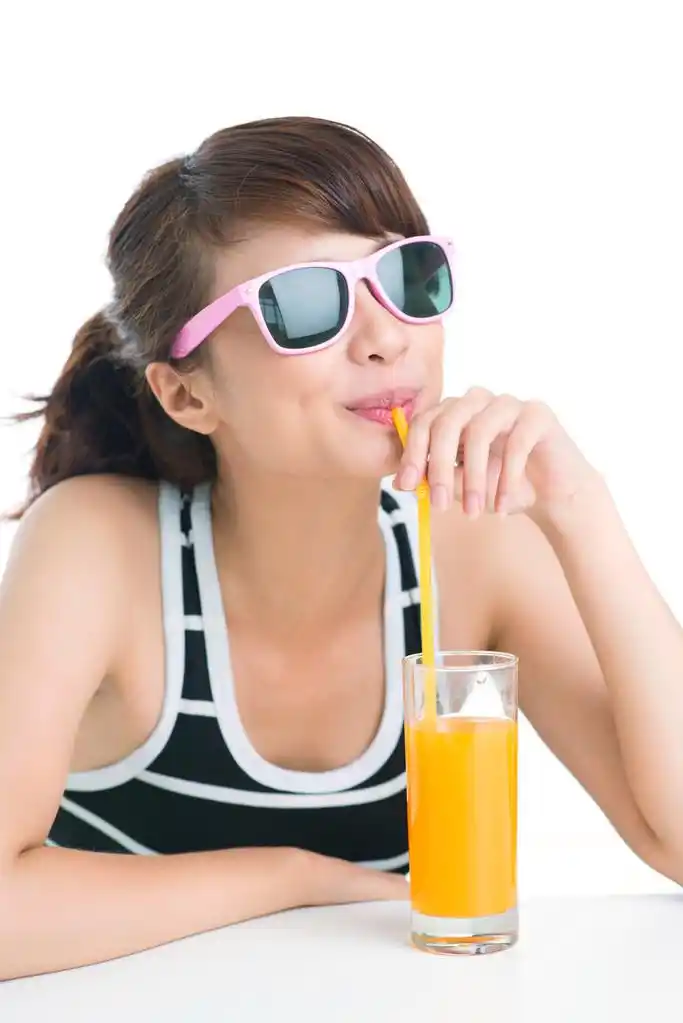 充分的维生素,很酷的女孩,小口喝橙汁吸管的孤立的形象