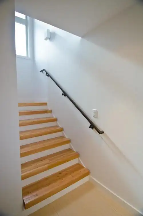 白色墙面黑色扶手木质台阶楼梯装修效果图