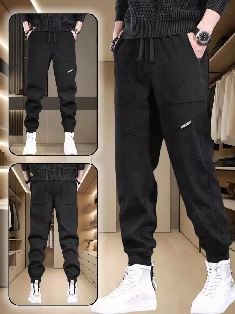 这款黑色宽松男裤实用且百搭,中腰长裤设计,宽松版型和流行元素的口袋