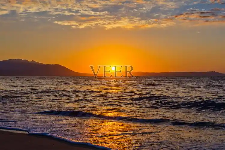 清晨壮观的日出越过大海和高山摄于希腊阿斯普罗瓦尔塔照片摄影图片