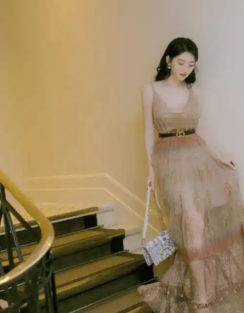 为了让造型更加吸睛亮眼,景甜这款深v吊带裙,裙身采用"金丝绣花"的