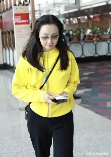 陶虹穿明黄色上衣搭配黑裤素颜走机场,简约随意,一般女星做不到