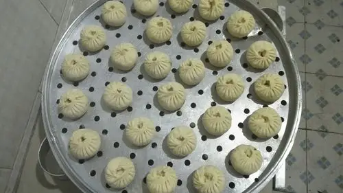 包好的包子犹如一朵朵鲜花绽放在笼屉里