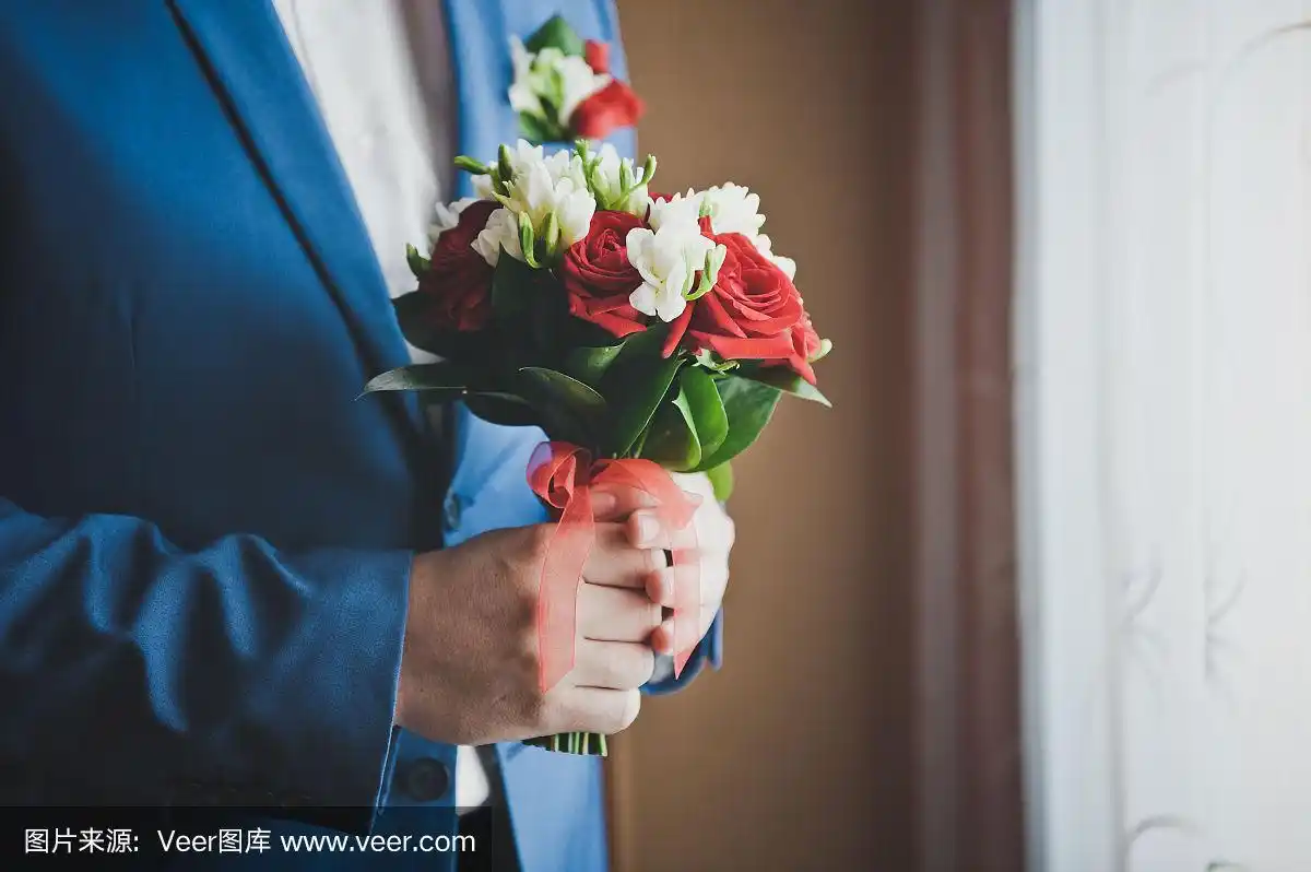 蓝色西装男子手中的花束.