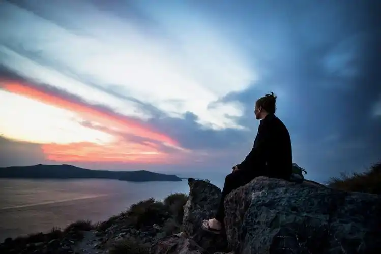 空 br /> 独自坐在悬崖边看夕阳的女子