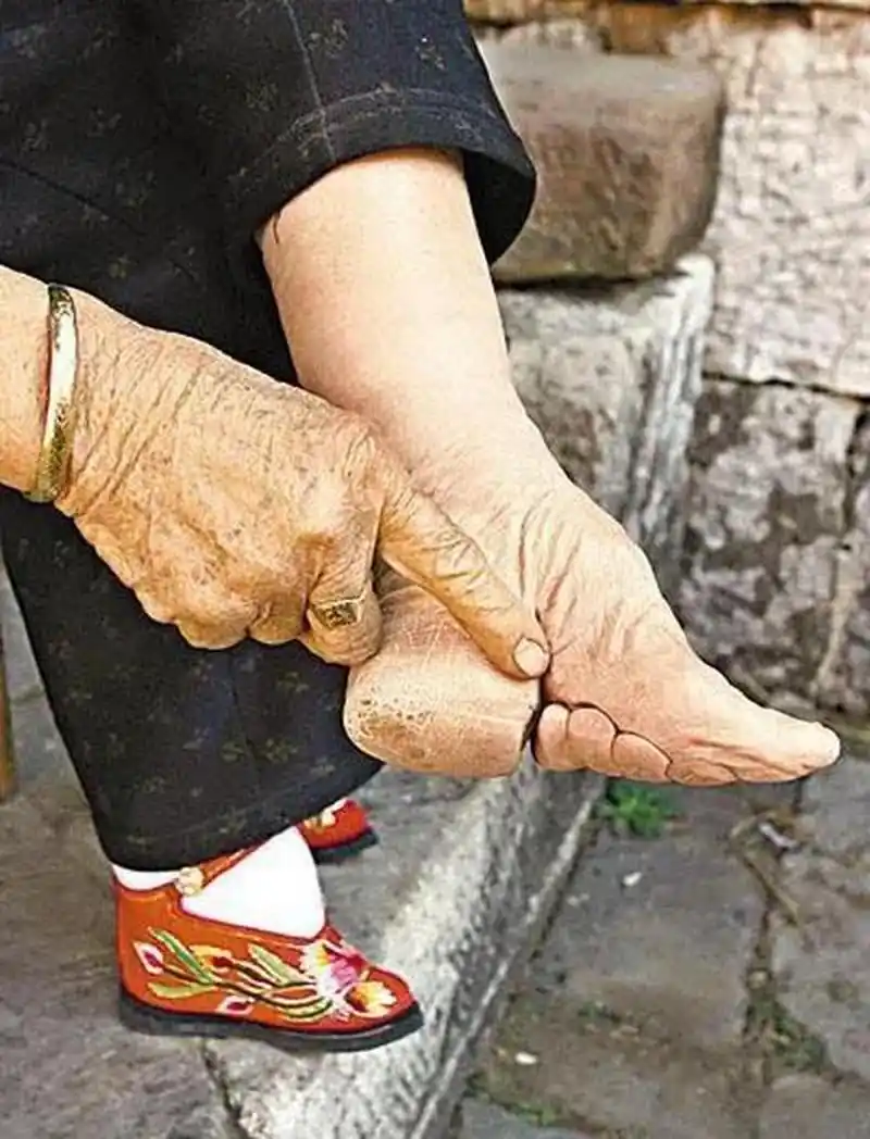 一个清朝裹小脚的姑娘在西洋摄影师的强烈要求之下打开了她的裹脚布