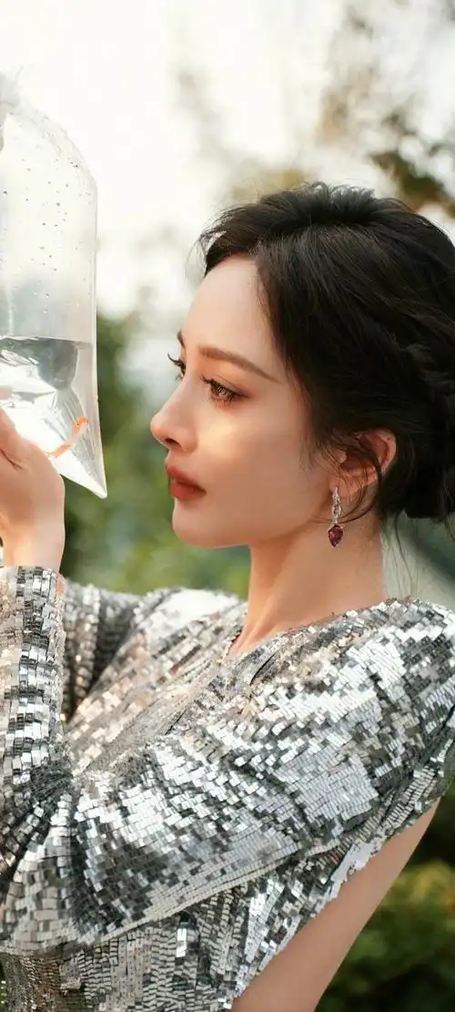 在这组壁纸中,杨幂身穿一袭银色亮片裙,展现出她的优雅与高贵.