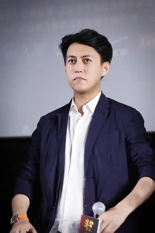 45岁靳东又升官了,穿一身灰西装出席会议低调站边上,央视脸超帅