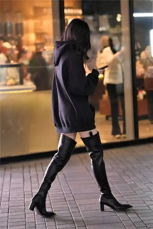 就是为了自己更美一些,这位美女选择一双黑色过膝长靴,大腿靴的设计