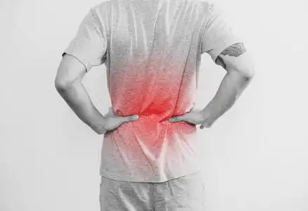 一个男人用红色的亮点抚摸着他的背部.背部疼痛,背痛和腰部疼痛照片