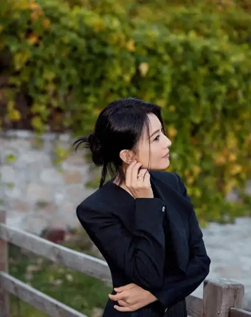 高圆圆参加电影展,黑色长裙落落大方,双手抱胸面露笑容气质优雅