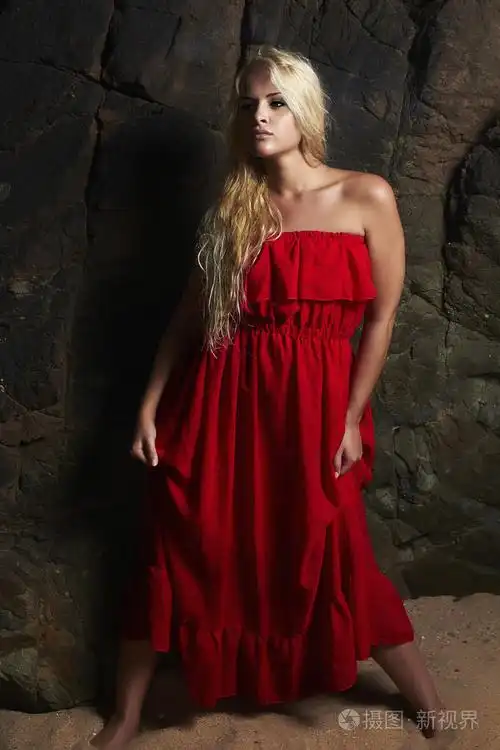 穿红衣服的金发碧眼美女.构成的岩石附近的女孩.夏天