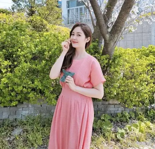 41岁成宥利产后首晒照,鲜花挡肚四肢略肿,当妈后少女感不改