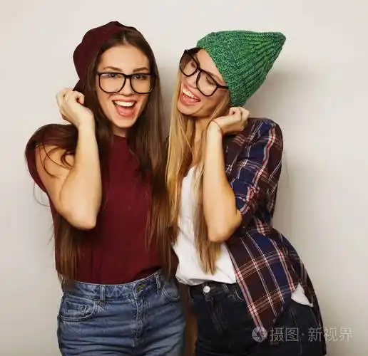 两个年轻的女朋友站在一起玩得很开心