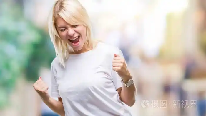 白色t恤,在孤立的背景下,非常高兴和兴奋地做着胜利者的手势,手臂抬起