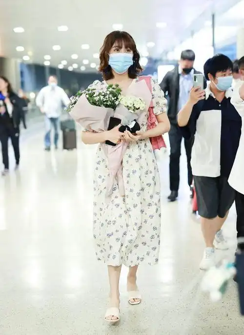 李艺彤穿白色碎花裙背着粉色包包手捧鲜花太迷人像个小公主