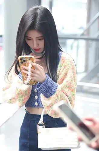 鞠婧祎机场撩发妩媚动人 穿香芋紫短上衣大秀纤腰