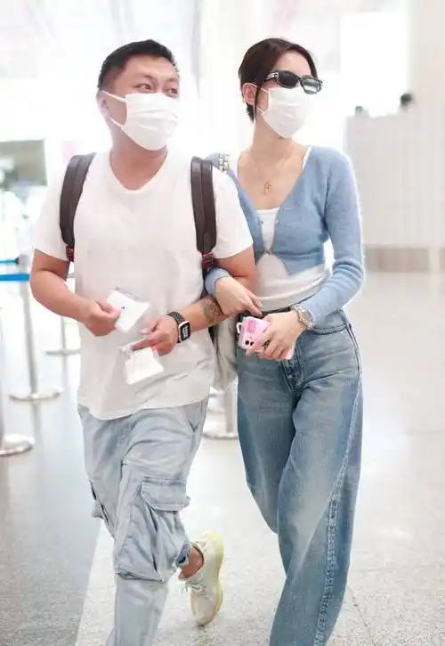 孙怡走机场真放得开,穿露脐装手挽经纪人,董子健也不管管
