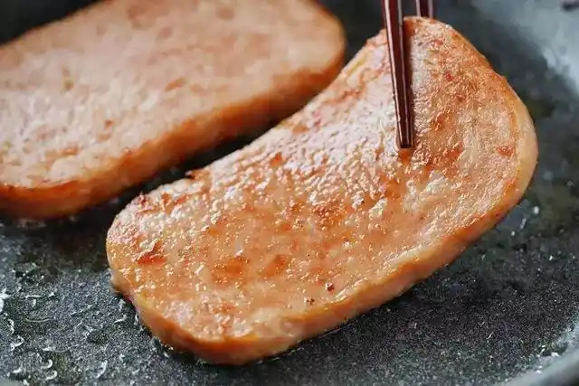 5,最后,按口味和饭量,少油小火煎几片午餐肉,煎到两面金黄就可以了.