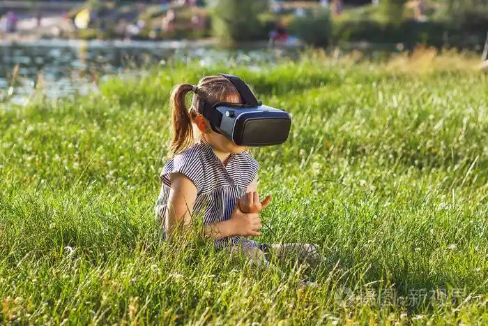 小女孩玩游戏与虚拟现实眼镜户外