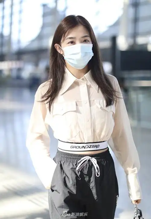 张含韵穿短上衣秀蛮腰双手插兜赶路十分随性