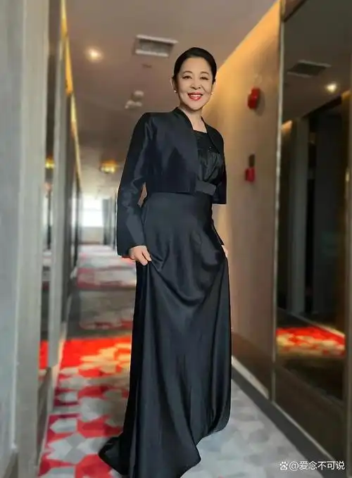 照片中,倪萍身穿深色连衣裙,脖子上系着丝巾,脚上穿着一双红色休闲网