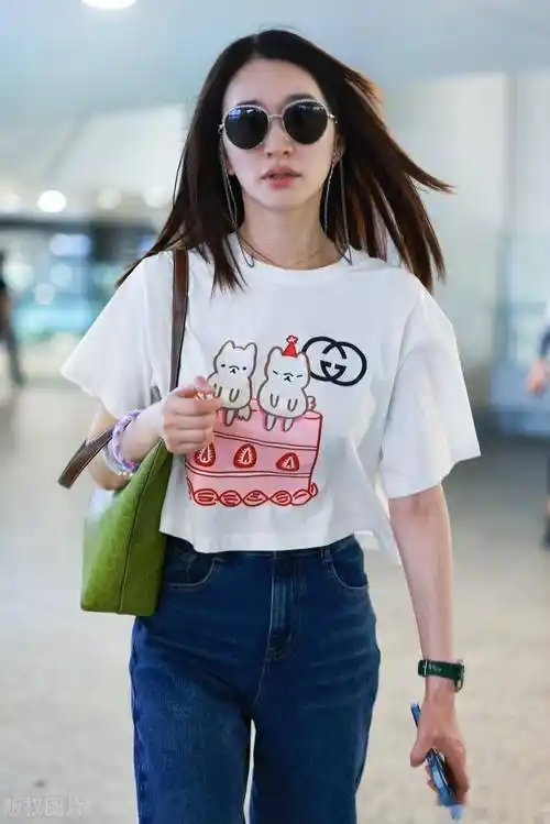 街拍:李小冉白色卡通印花t恤 牛仔裤 绿色腋下包可爱减龄_上海_机场