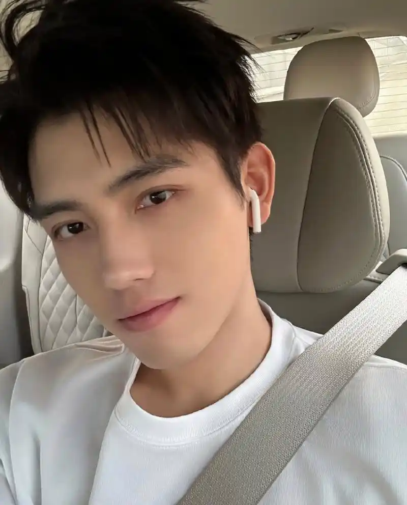 陈飞宇素颜坐在车里自拍,系着安全带,戴着耳机,生活气息十足.