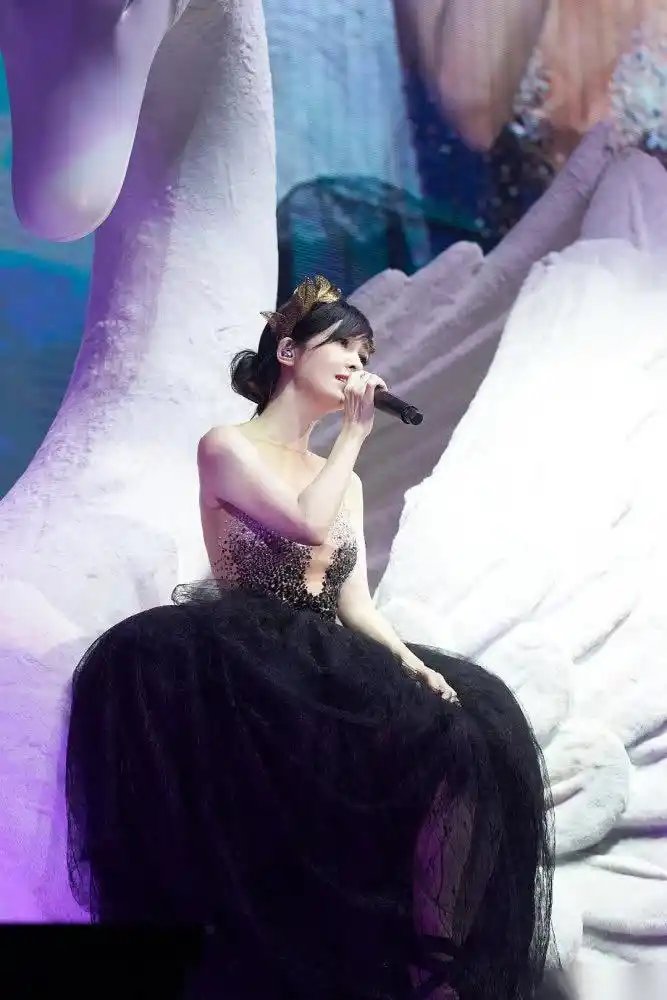 周慧敏在小巨蛋演唱会的演出照,身穿蓬松白裙美似天鹅少女.