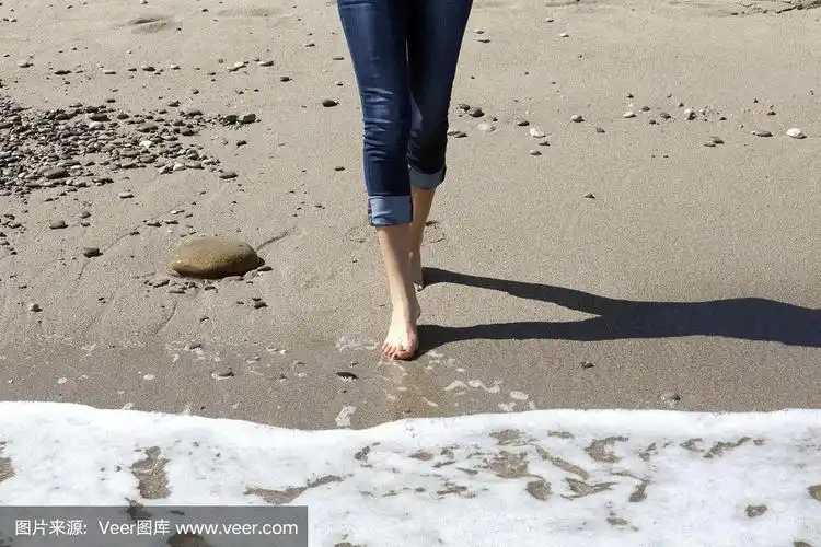 在海滩上赤脚行走的女人