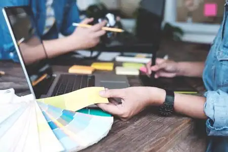 年轻的摄影师和平面设计师在工作室办公室工作照片